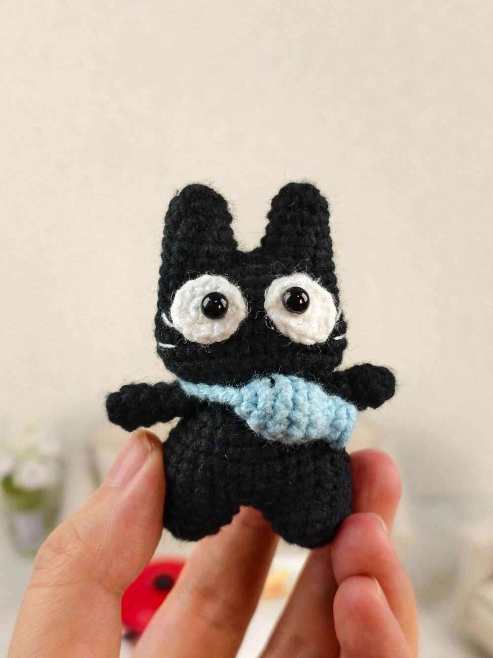 Handmade Amigurumi Crochet Cat Carrying A Blue Fish Plushie